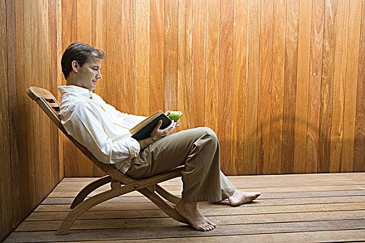 男人,坐,休闲椅,读,书本,苹果,拿着,侧面视角