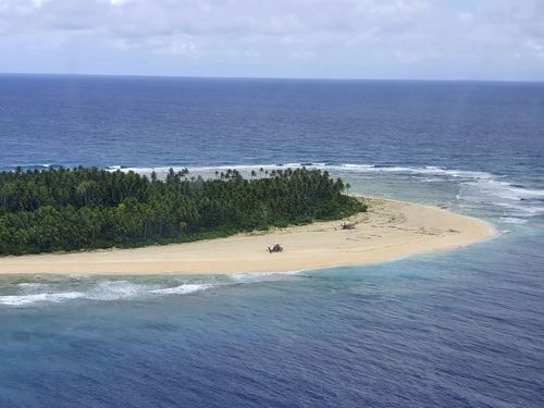 3 men rescued from pacific island after writing sos in sand