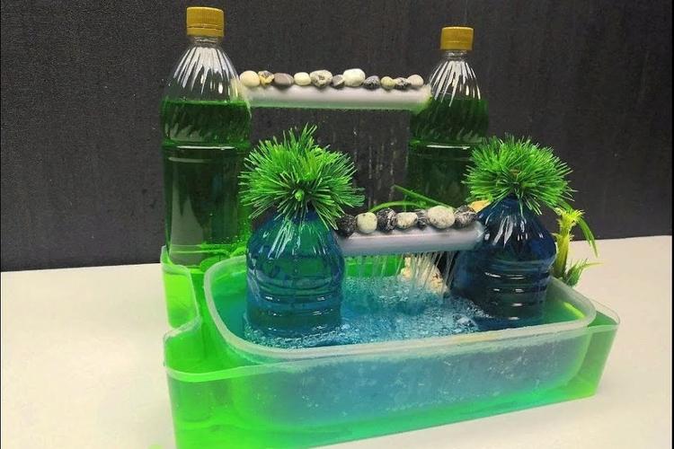用喝完的矿泉水瓶制作一个微型的喷泉瀑布摆在家里欣赏