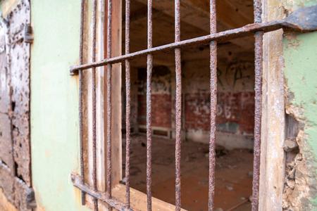 铝艺大门铁窗上锈迹斑斑的大门后面,废弃的监狱照片