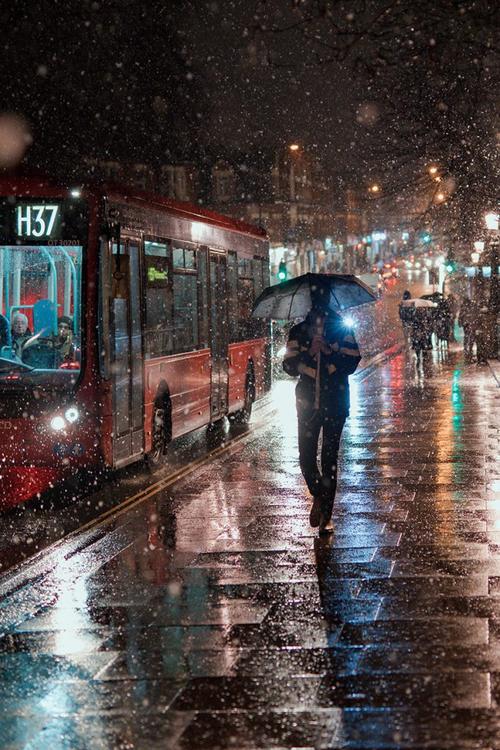 下雨天的都市街道公交车打伞的男人 - 开先生